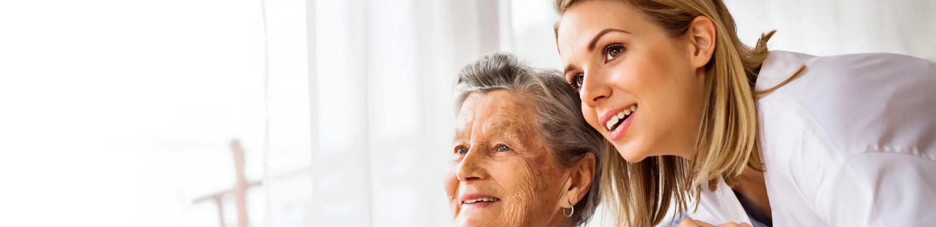 Health visitor and a senior woman during home visit.